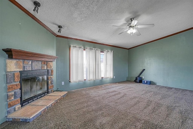 unfurnished living room featuring ceiling fan, a stone fireplace, carpet floors, and a textured ceiling