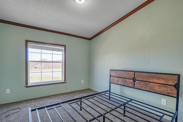 unfurnished bedroom with crown molding, a textured ceiling, and carpet