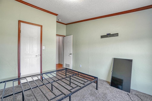 unfurnished bedroom featuring crown molding, carpet flooring, and a textured ceiling