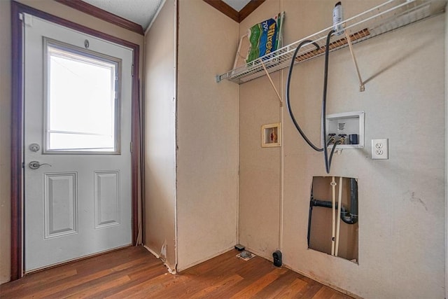 clothes washing area featuring hardwood / wood-style flooring, ornamental molding, and washer hookup