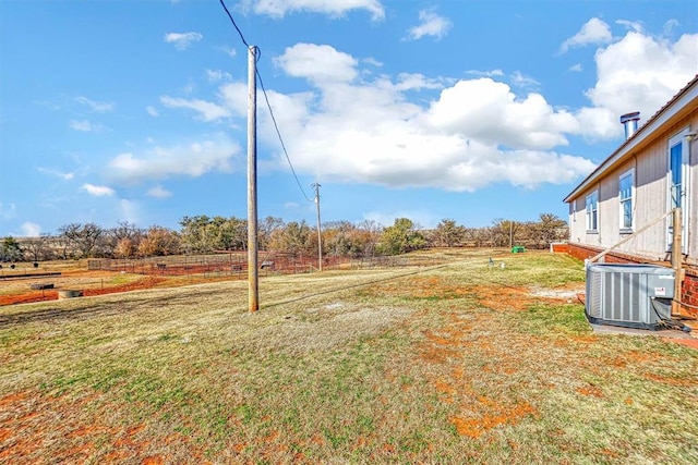 view of yard featuring central AC and a rural view