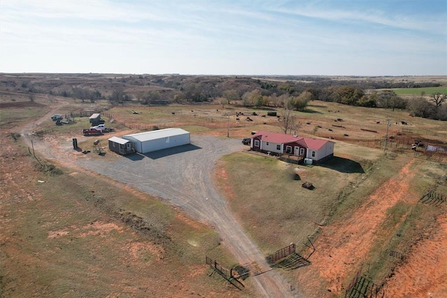 birds eye view of property with a rural view