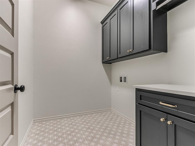 clothes washing area featuring washer hookup and cabinets