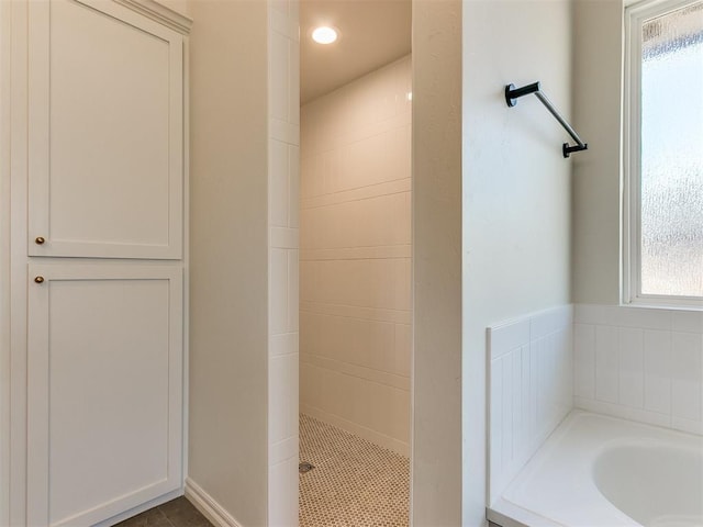 bathroom featuring tile patterned flooring and independent shower and bath