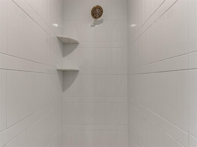 interior details with a tile shower