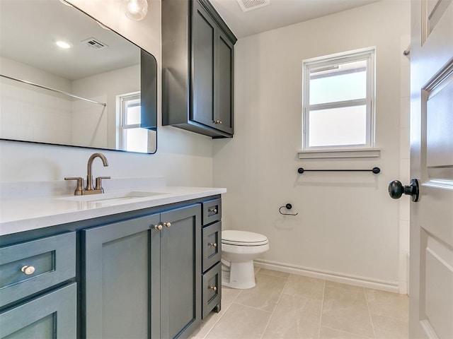 bathroom featuring tile patterned floors, vanity, and toilet