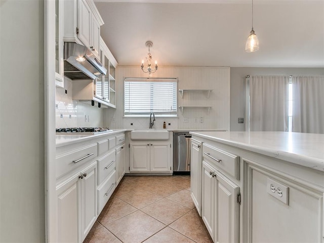 kitchen featuring white cabinetry, sink, hanging light fixtures, decorative backsplash, and appliances with stainless steel finishes