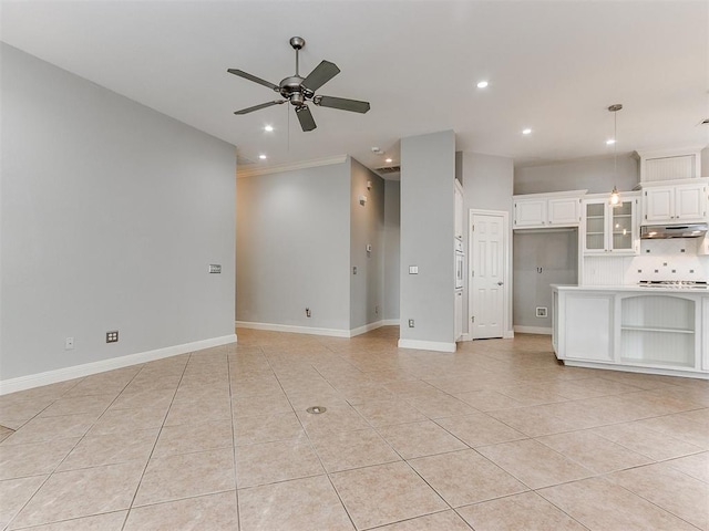 unfurnished living room featuring ceiling fan, light tile patterned floors, and ornamental molding