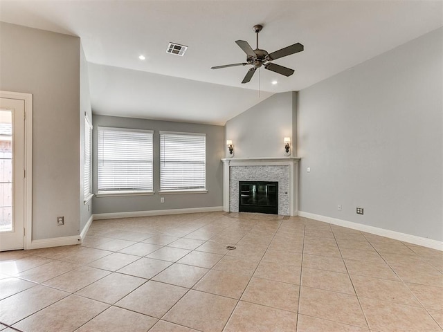 unfurnished living room featuring ceiling fan, plenty of natural light, light tile patterned flooring, and lofted ceiling