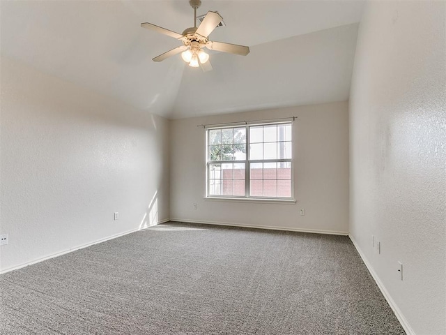 empty room featuring carpet flooring, vaulted ceiling, and ceiling fan