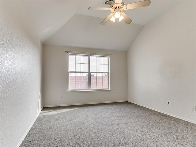 carpeted empty room featuring ceiling fan and vaulted ceiling