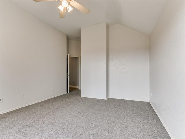 empty room featuring ceiling fan, lofted ceiling, and carpet floors