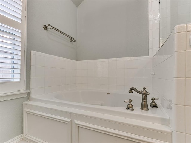 bathroom featuring a wealth of natural light and a bathing tub