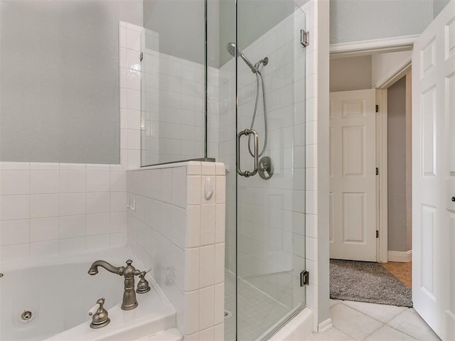 bathroom with shower with separate bathtub and tile patterned floors