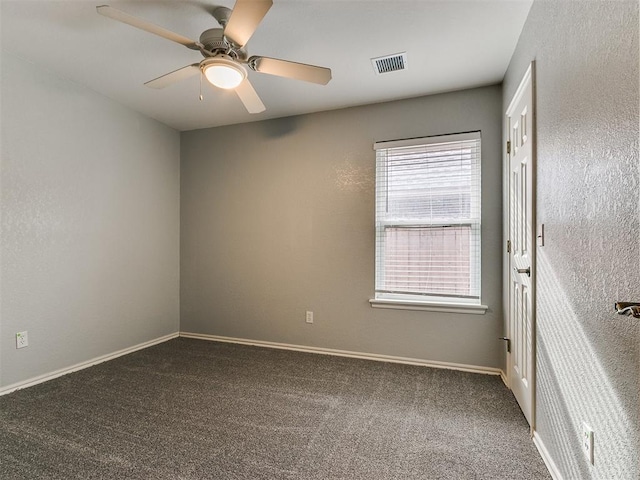 carpeted spare room with ceiling fan