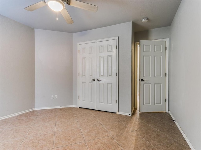 unfurnished bedroom with ceiling fan, a closet, and light tile patterned floors