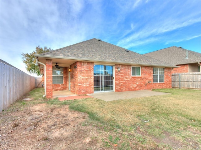 rear view of property featuring a patio, ceiling fan, and a lawn