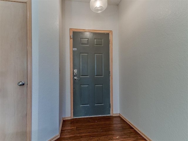 entryway with dark hardwood / wood-style flooring