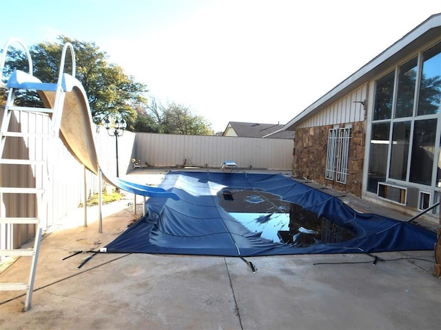 view of pool featuring a patio area and a water slide