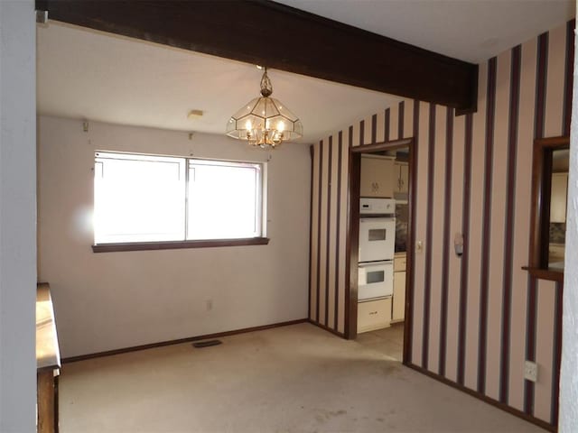 8300 Brookridge Dr, Oklahoma City, OK 73132 - empty room with beamed ceiling, a chandelier, and light colored carpet