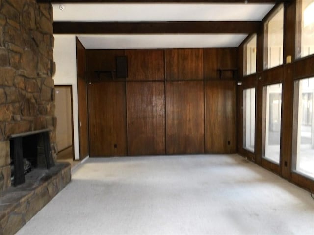 8300 Brookridge Dr, Oklahoma City, OK 73132 - unfurnished living room with a fireplace, light carpet, beamed ceiling, and wood walls