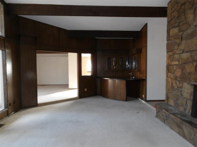 8300 Brookridge Dr, Oklahoma City, OK 73132 - unfurnished living room featuring beam ceiling, light colored carpet, and bar