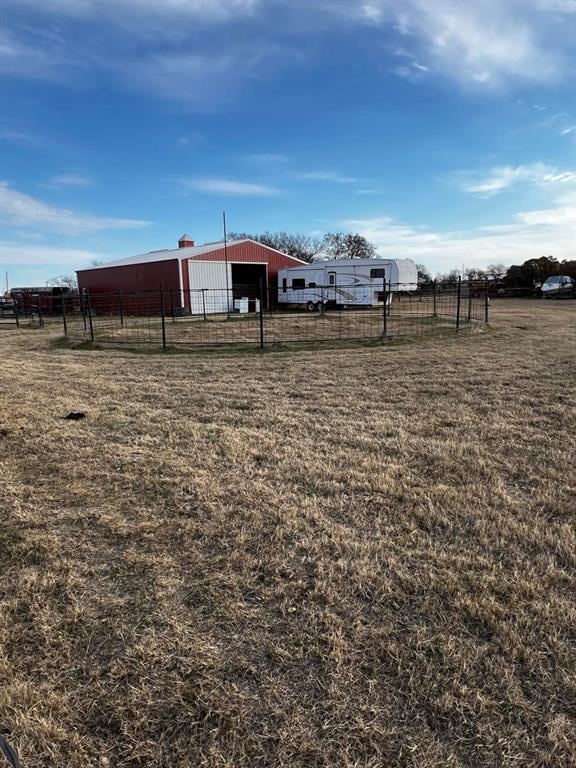 view of yard featuring an outbuilding and a rural view