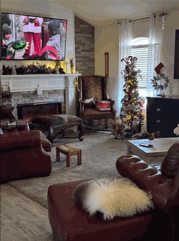 living room with a fireplace and vaulted ceiling