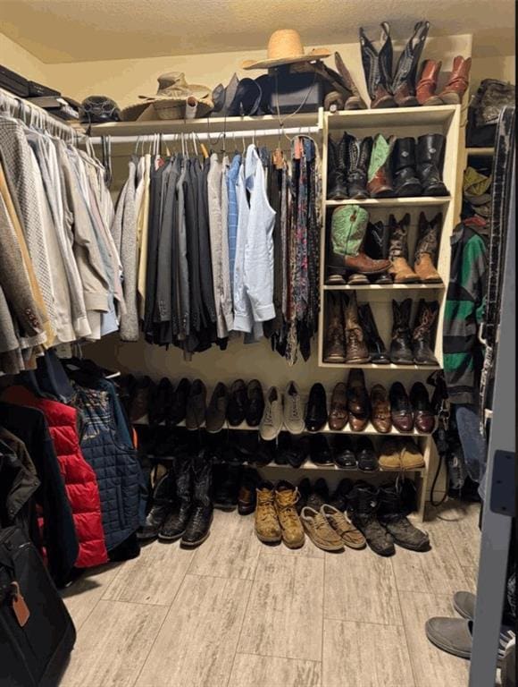 walk in closet with hardwood / wood-style flooring