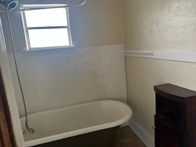 bathroom featuring tile patterned floors and a bathtub