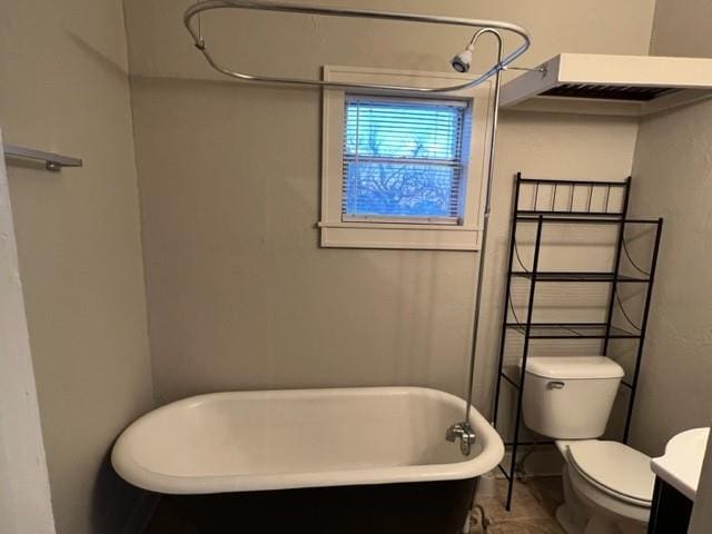 bathroom featuring toilet and a bath