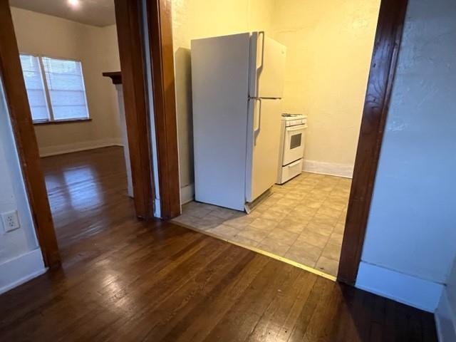 kitchen featuring light hardwood / wood-style floors and white appliances