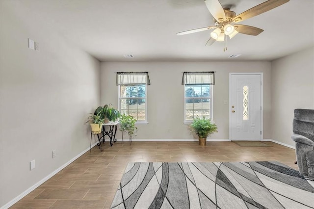 foyer entrance featuring ceiling fan