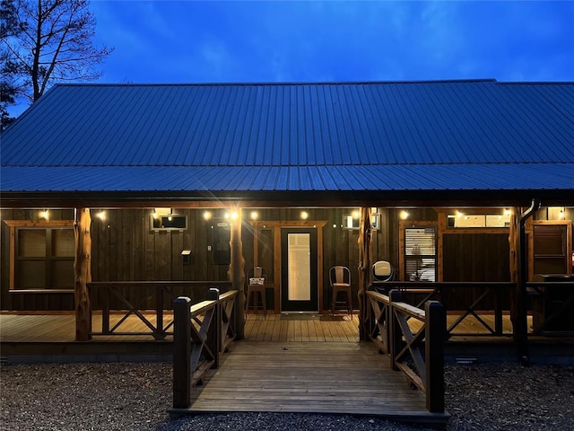 back house at dusk with an AC wall unit