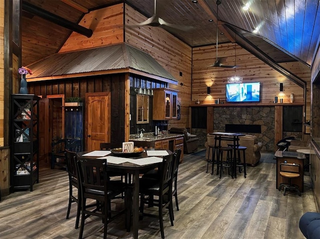 dining room with ceiling fan, dark hardwood / wood-style flooring, and wooden ceiling