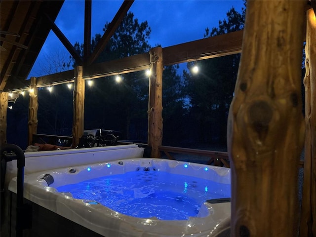 view of swimming pool with a hot tub