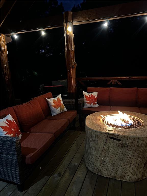 deck at twilight with a fire pit