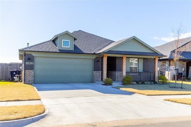 view of front of property with a porch and a garage