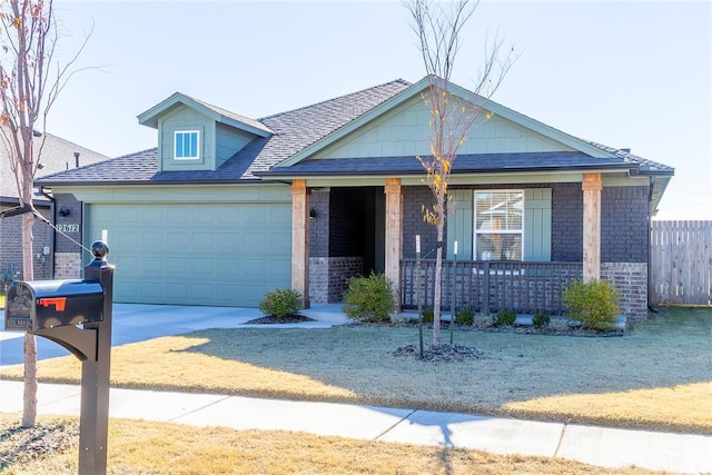 view of front of home featuring a porch and a garage