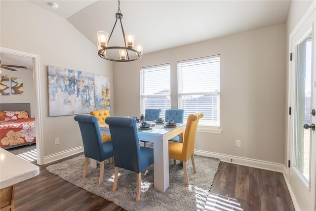 dining space featuring dark hardwood / wood-style floors, an inviting chandelier, a wealth of natural light, and lofted ceiling