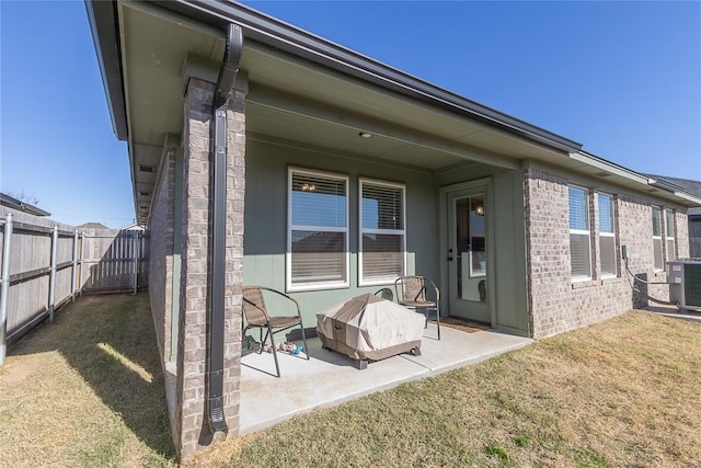 back of property featuring a lawn, a patio area, and central air condition unit