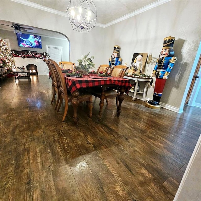 dining space with hardwood / wood-style flooring, ceiling fan with notable chandelier, and ornamental molding