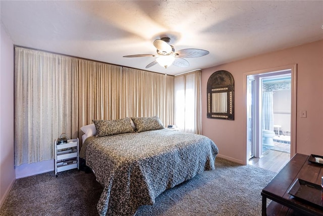 carpeted bedroom with a ceiling fan, multiple windows, baseboards, and ensuite bathroom