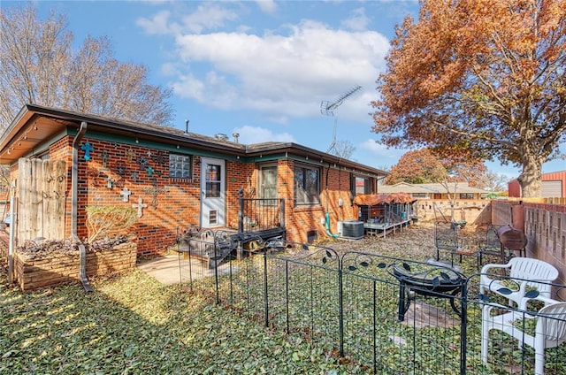 back of house with brick siding, a patio, and a fenced backyard