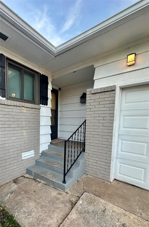 doorway to property featuring a garage