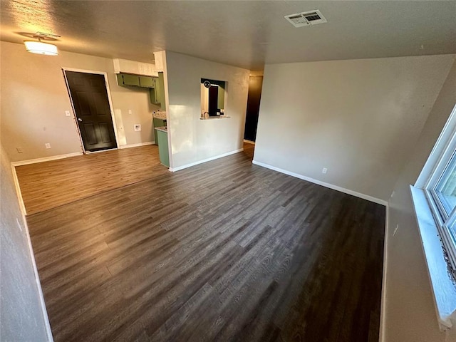 unfurnished living room with dark hardwood / wood-style flooring