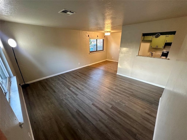 empty room with dark hardwood / wood-style flooring