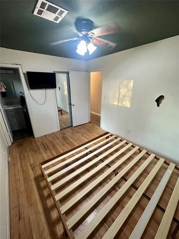 unfurnished bedroom featuring ceiling fan and hardwood / wood-style floors