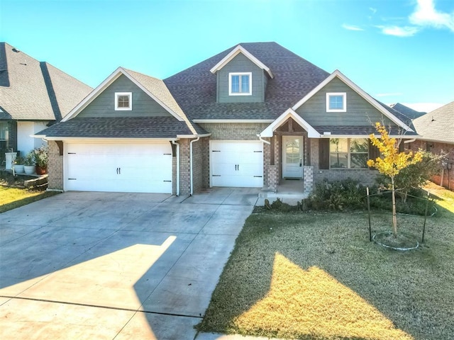 craftsman house featuring a front yard and a garage