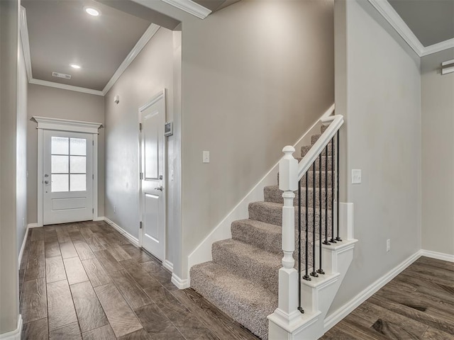 foyer entrance with dark hardwood / wood-style floors and ornamental molding